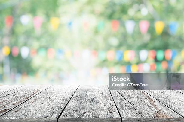 Empty Wooden Table With Party In Garden Background Blurred Stock Photo - Download Image Now