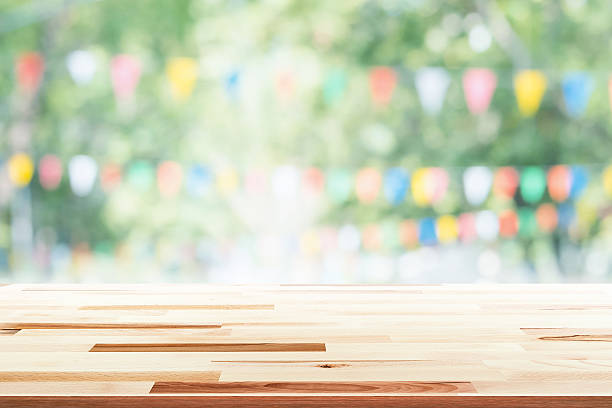 istock Empty wooden table with party in garden background blurred. 599716938