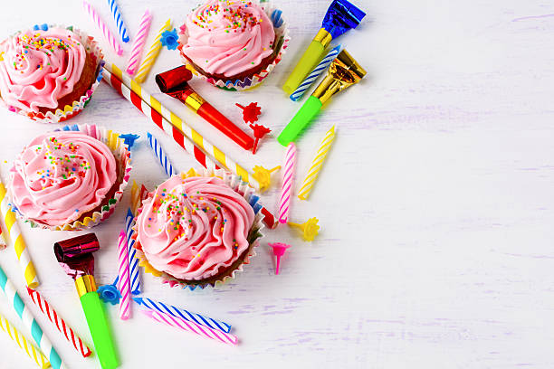 istock Birthday background with pink cupcakes and candles 599717000