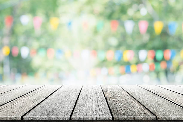 istock Empty wooden table with party in garden background blurred. 599717038