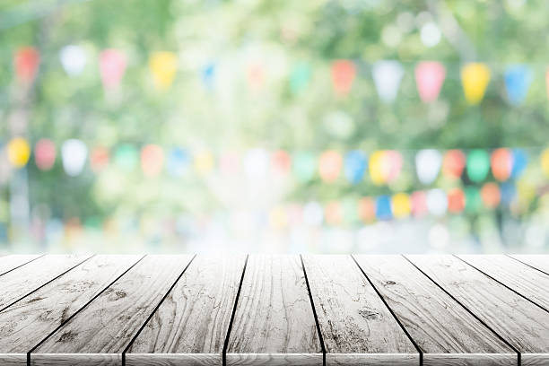 istock Empty wooden table with party in garden background blurred. 599717106