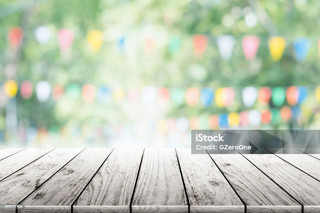 Empty wooden table with party in garden background blurred. Empty wooden table with party in garden background blurred.Empty wooden table with party in garden background blurred. Alcohol - Drink Stock Photo