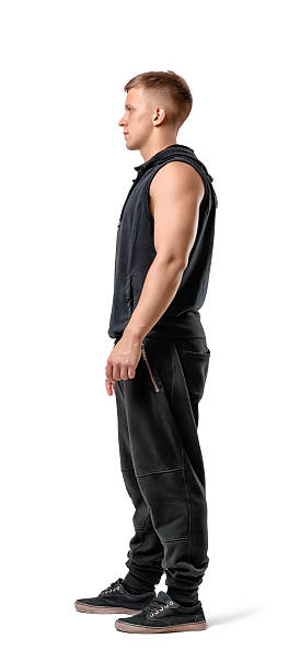 istock Side view of muscled young man standing, isolated on white 599717898