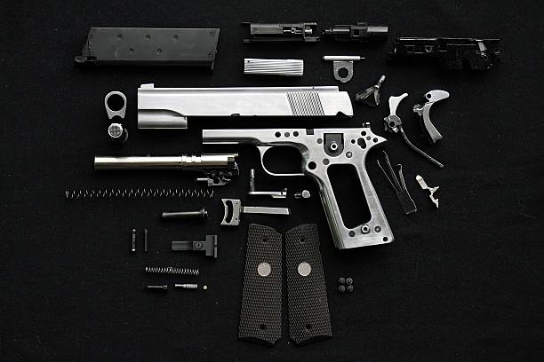 Disassembled handgun Disassembled handgun on black background dismantling photos stock pictures, royalty-free photos & images