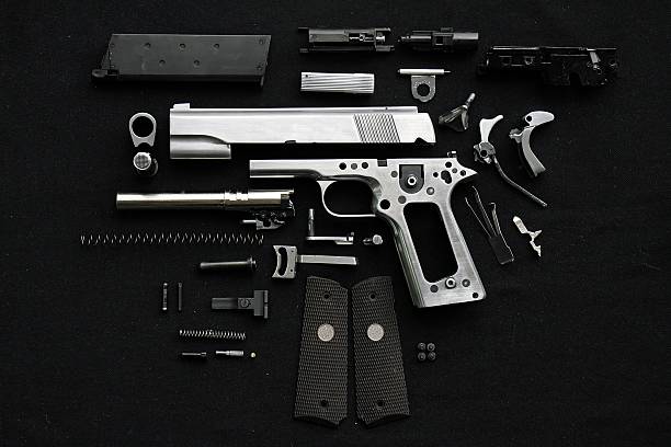 Disassembled handgun Disassembled handgun on black background gun revolver stock pictures, royalty-free photos & images