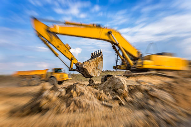 Yellow road construction machinery in action on new highway S3 construction