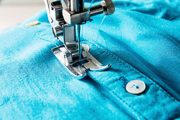 istock Closeup of sewing machine with blue cloth 599747052