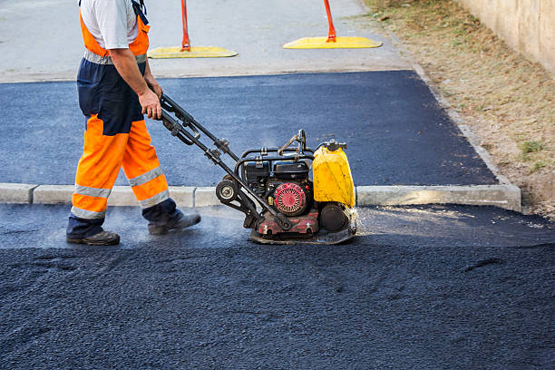 Worker use vibratory plate compactor Worker use vibratory plate compactor compacting asphalt at road repair compactor photos stock pictures, royalty-free photos & images