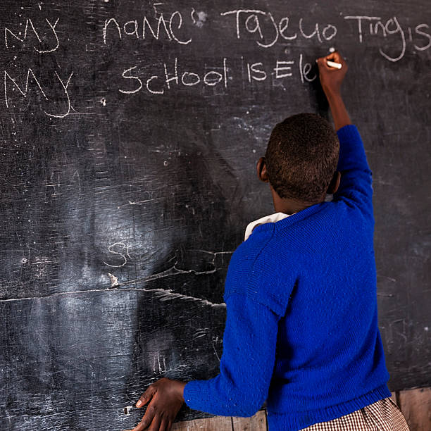 istock African young girl is learning English language, Kenya 599747734
