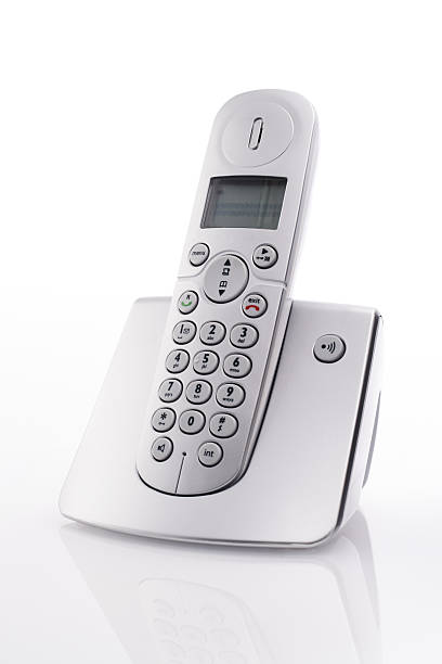Cordless landline telephone on charger Cordless landline telephone in docking station cordless phone stock pictures, royalty-free photos & images