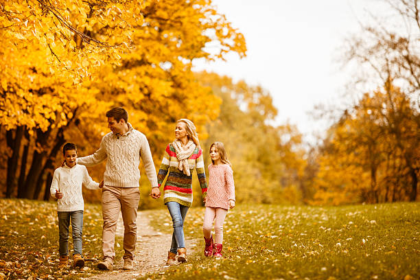 istock Family walking in park during autumn 599752194