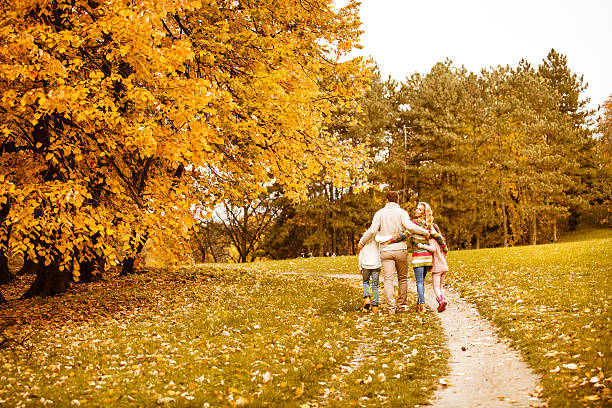 istock Family walking in park in autumn 599752202