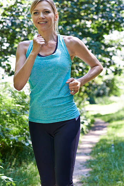 istock Mature Woman Running Outdoors In Countryside 599753776