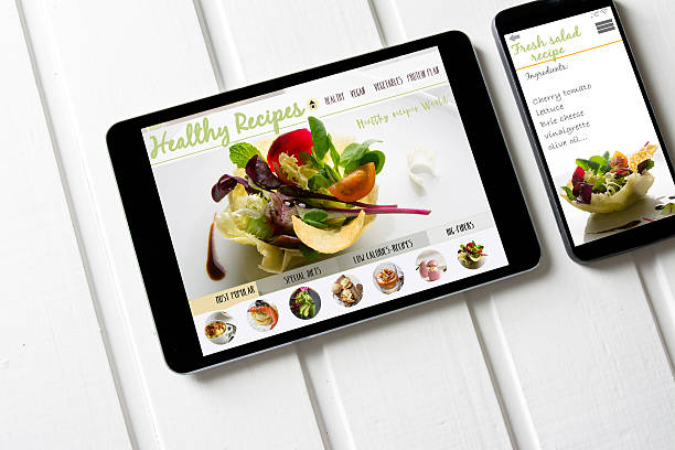 istock tablet and smartphone healthy recipes blog on screen. 599754330