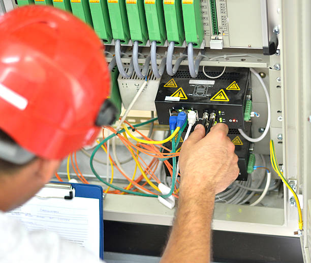 istock Engineer Connecting Fiber Optic Cable to the Switch 599755052