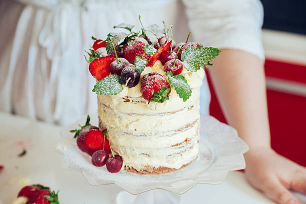 istock Woman Carefully Icing The Cake 599757354