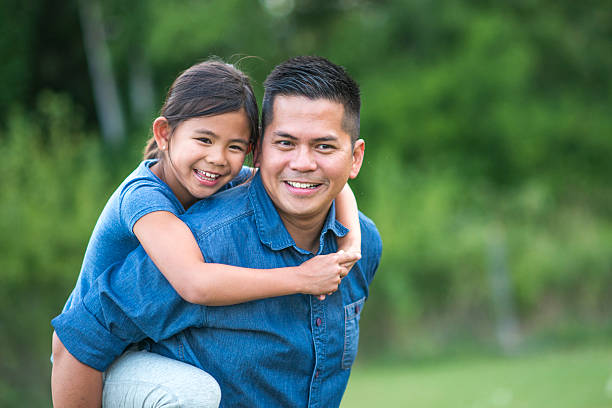 istock Father Carrying his Daughter on his Back 599758048