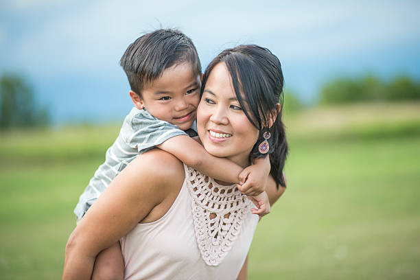 istock Mother Giving Son a Piggyback Ride 599758070