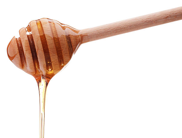 istock Honey dripping from a wooden honey dipper 599758634