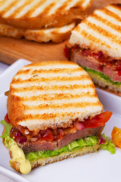 istock Beef Sandwich with Tomatoes, Coriander, Red Onion and Green Salad 599758746