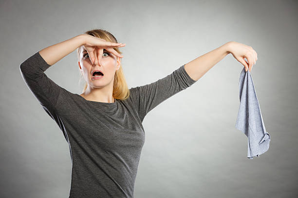 istock Girl with disgusting rag in hand. 599759330