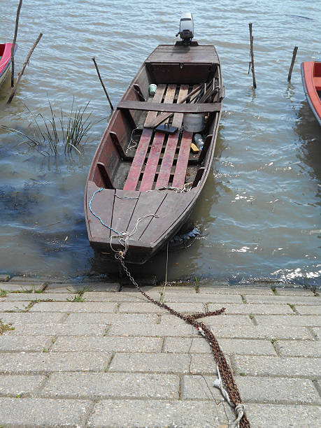 istock Wooden rowboat in the old marina 599759468