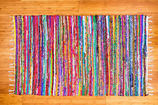 Photo of Close up colorful hand woven rug on bamboo floor