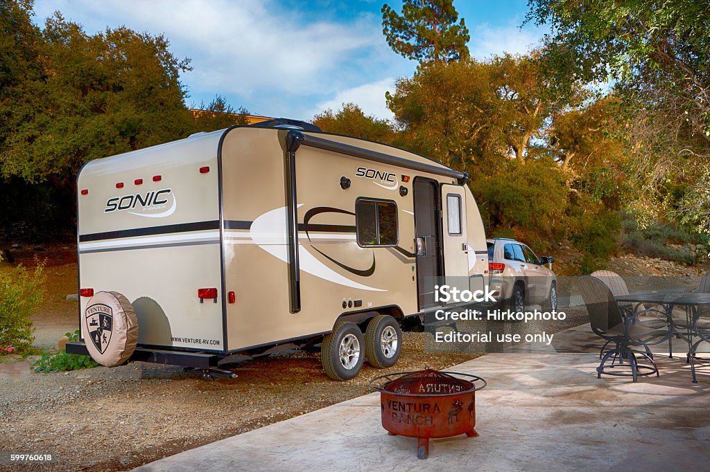 Travel trailer in campground Santa Paula, California USA - March 24, 2014: Jeep cherokee pulling a Sonic travel trailer in beautiful Ventura Ranch campground. 4x4 Stock Photo