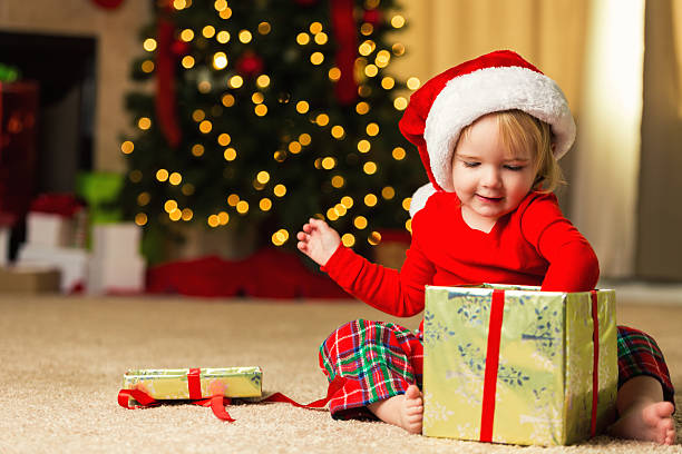 istock Precious little girl opening a Christmas present 599760864
