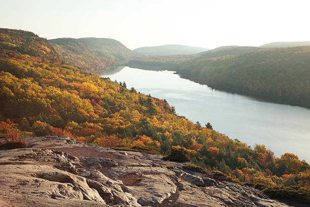 istock Bluffs and Trees Above Lake with Fall Colors in Michigan 599761244