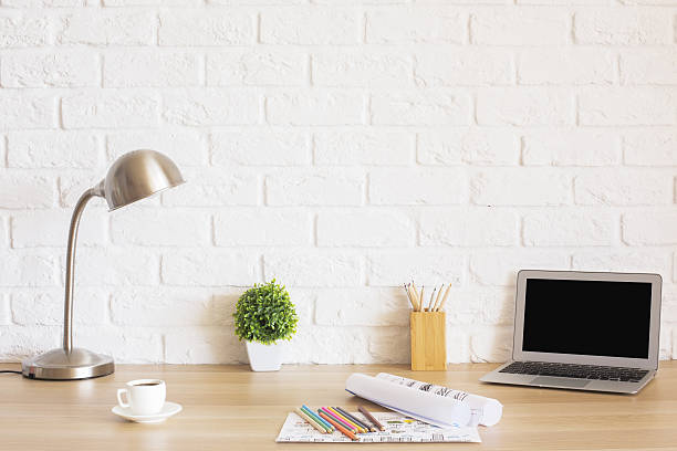 istock Desk with laptop and sketches 599761272
