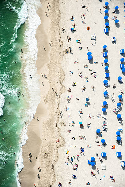 crowds sunbathing on the beach in miami crowds sunbathing on the beach in miami south beach photos stock pictures, royalty-free photos & images