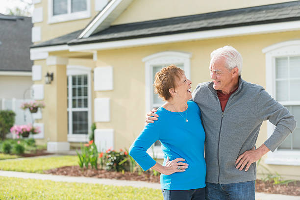 istock Loving senior couple standing outside home 599764534