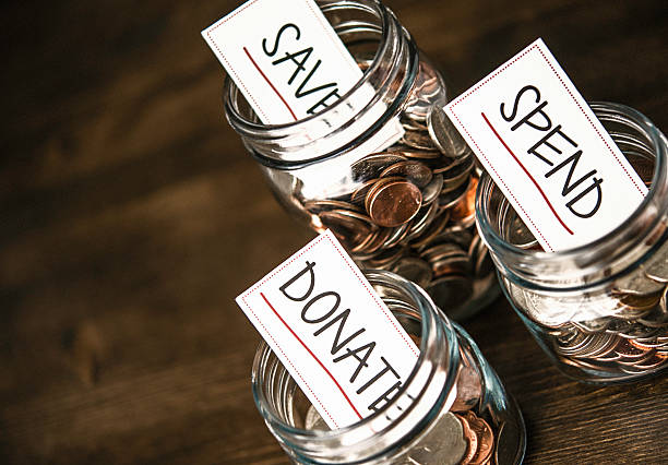 istock American currency jars labelled, Save, Spend, Donate. Budgeting concept. 599767836