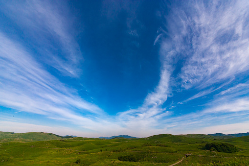 Floating layered clouds on blue sky background