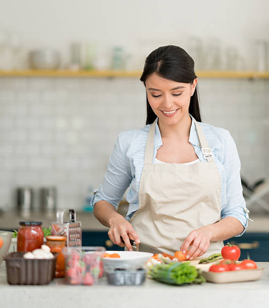 istock Woman cooking dinner at home 599768718