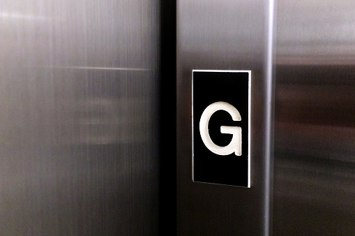 The letter G on elevator lift door