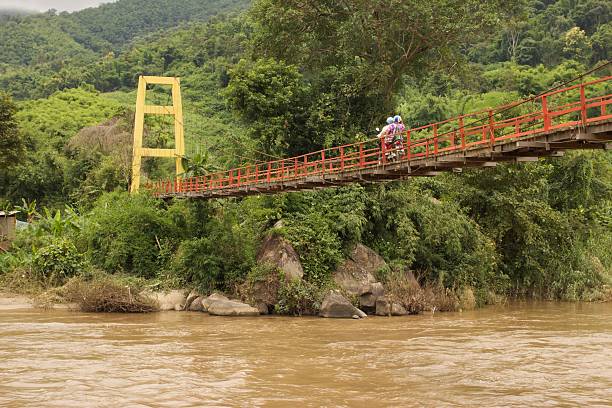 Wooden suspension bridge across the Kok river in Chiangrai the northern of Thailand.