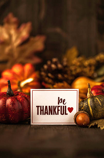 istock Thanksgiving still life background with pumpkins, acorns and message 599774282