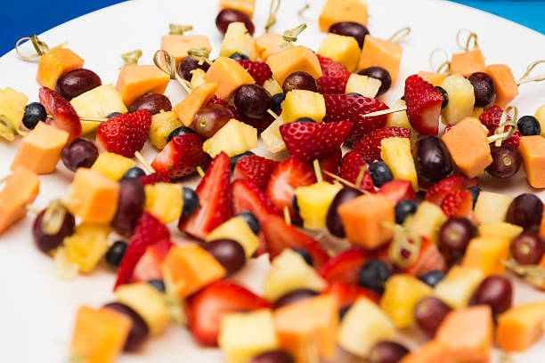 istock Plate of fruit and cheese kebabs for party snacks 599776260