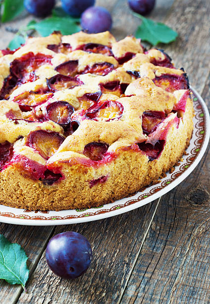 istock rustic plum cake on dark wooden background 599776504
