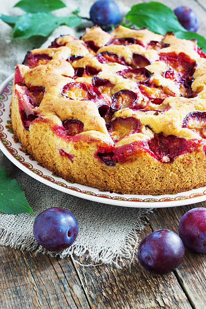 istock rustic plum cake on dark wooden background 599777338