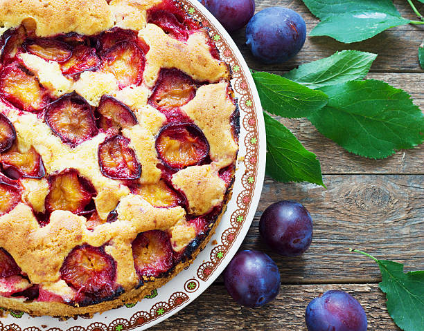 istock rustic plum cake on dark wooden background 599778462