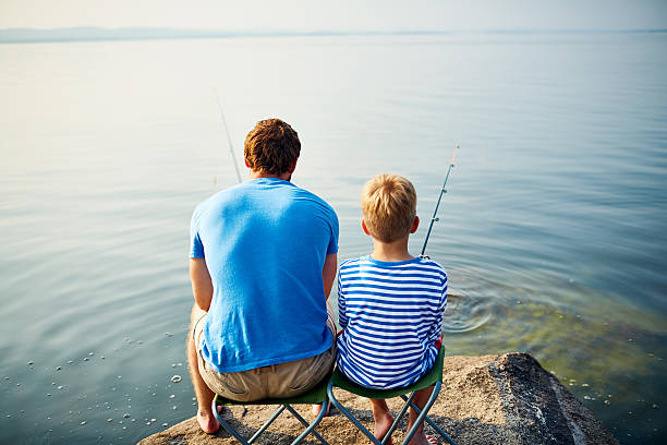 istock Backs of fishermen 599779886