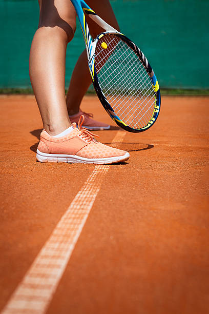 istock Female tennis player legs 599779996