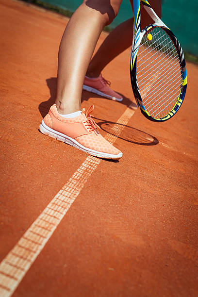 istock Female tennis player legs 599780118