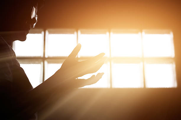 istock Respect and pray in the room with sunrise through window 599780630