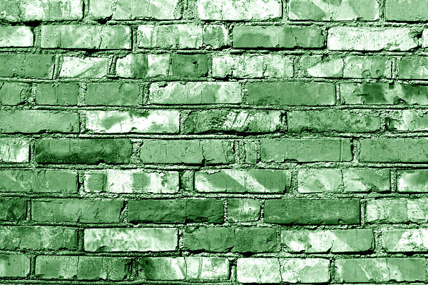 istock Grungy green toned brick wall texture. 599780804