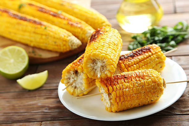 istock Tasty grilled corn on brown wooden table 599781470
