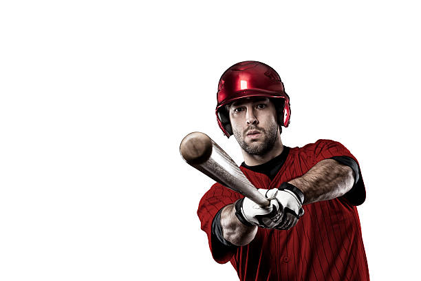 Baseball Player Baseball Player with a red uniform on white background. men baseball baseball cap baseball bat stock pictures, royalty-free photos & images